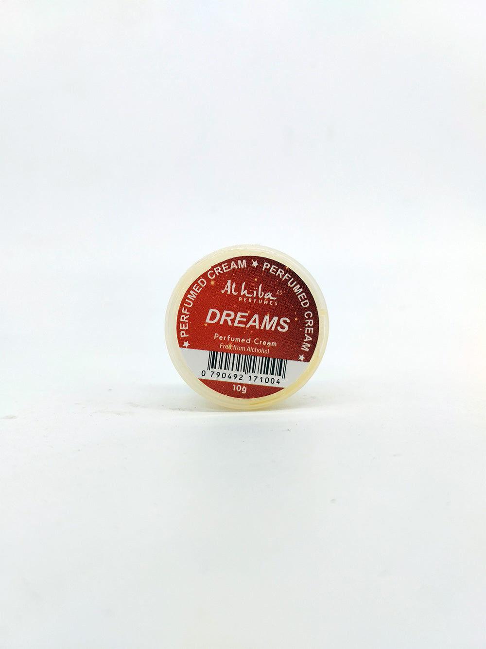 Small container of 'Dreams' perfume cream on a white background