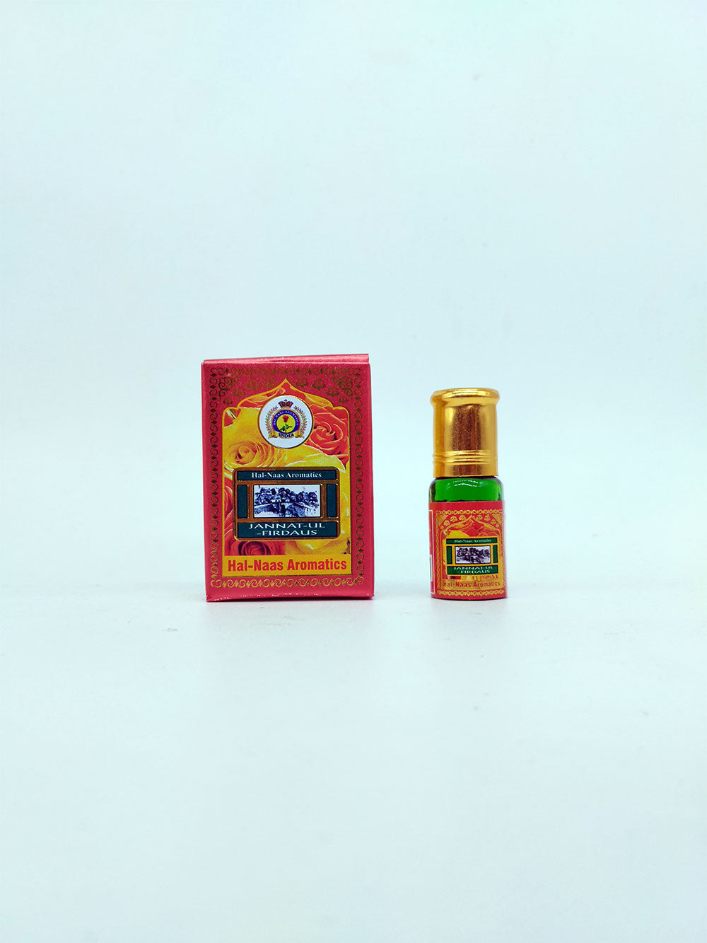 Small jannatul firdaus bottle and box with a red label on a light blue background